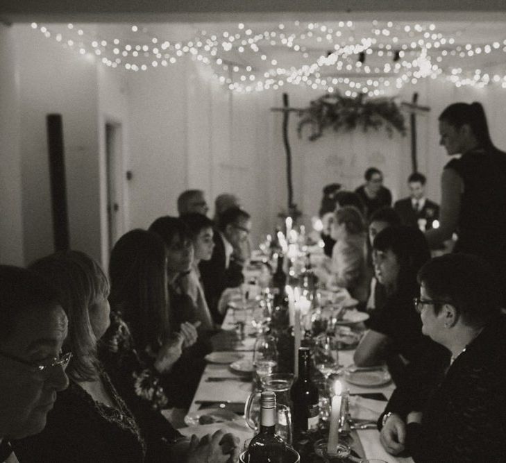 Guests celebrating at Linden House for a intimate and relaxed dinner reception with festoon lighting