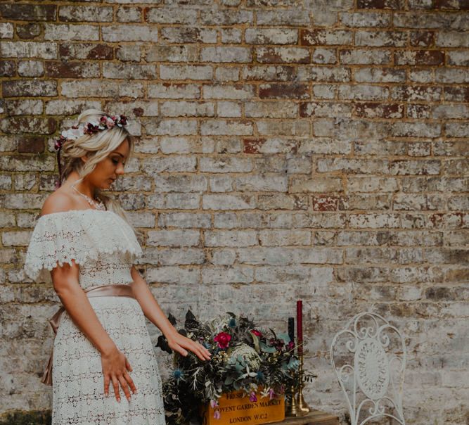 Boho Bride in Lace Wedding Dress Standing Next to Crate Wedding Decor