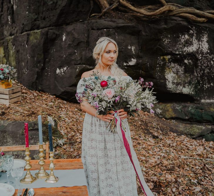 Bohemian Bride Standing at her Rustic Tablescape