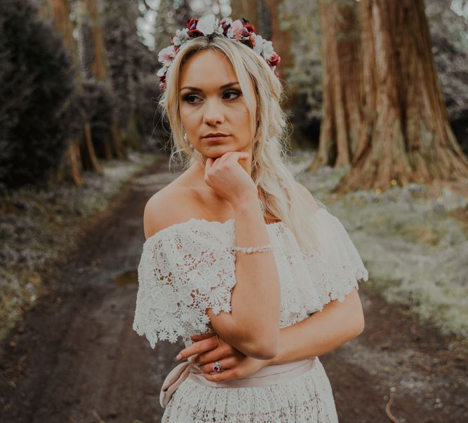 Boho Bride Standing in the Forest in a Lace Wedding Dress