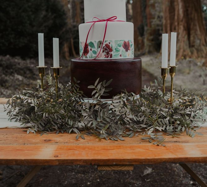 Three Tier Wedding Cake with Greenery Skirt and Gold Candle Stick Wedding Decor