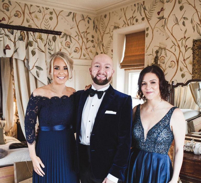 Groom in Tuxedo with Bridesmaids in Navy Dresses