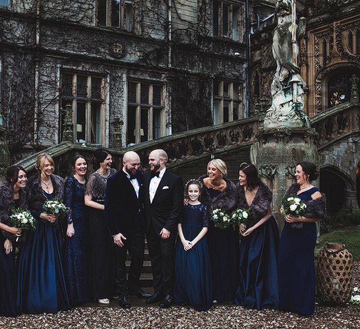 Groom and Groom and Bridesmaids in Navy Ball Gown Dresses and Faux Fur Stoles