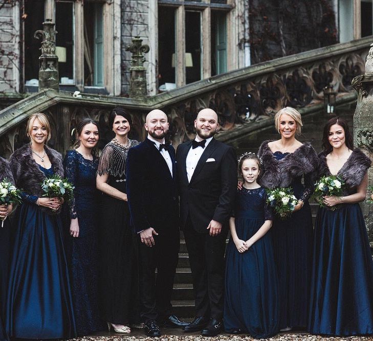 Groom and Groom and Bridesmaids in Navy Ball Gown Dresses and Faux Fur Stoles