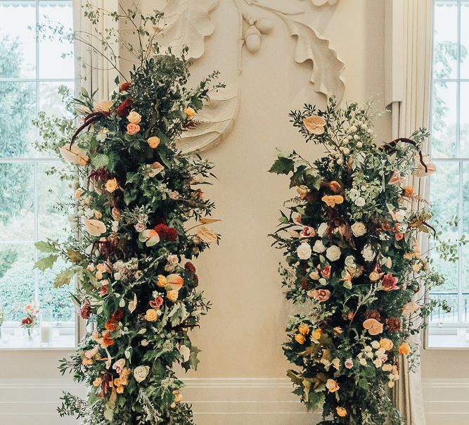 Altar at Coworth Park with vertical floral arrangements and candles