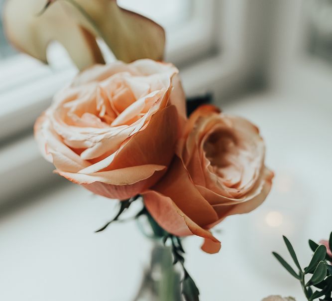 Coral flower stems in vase