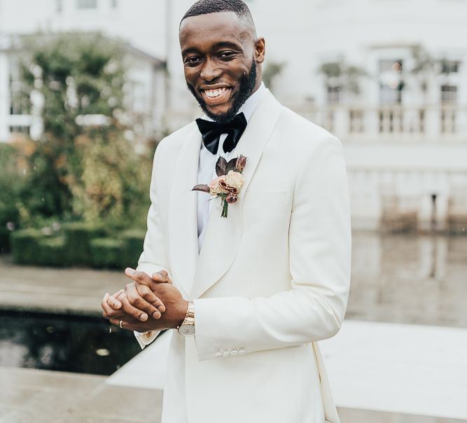 Stylish groom in white blazer for black-tie wedding