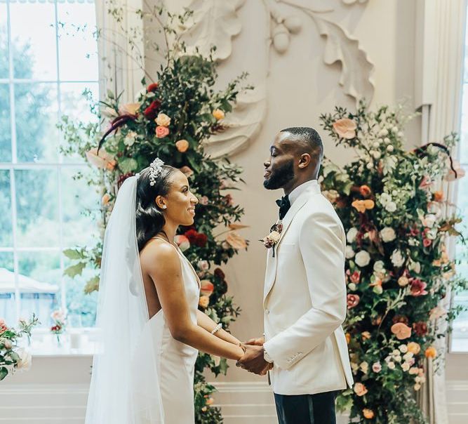 Bride and groom exchanging vows at intimate Coworth Park wedding ceremony