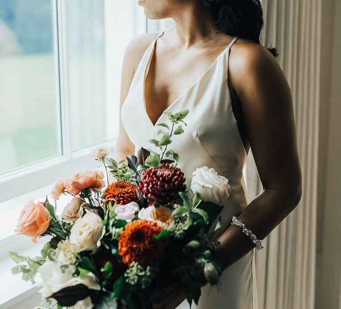 Beautiful bride in strappy wedding dress and pearl headdress