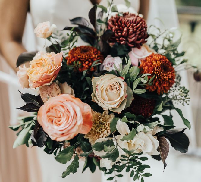 Autumn bridal bouquet with pinks, orange and green wedding flowers