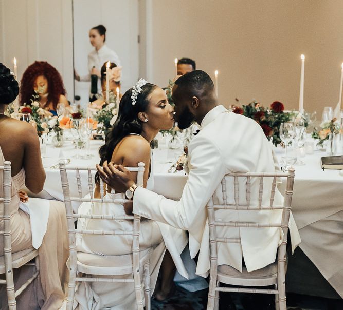 Bride and groom kissing at Coworth Park reception