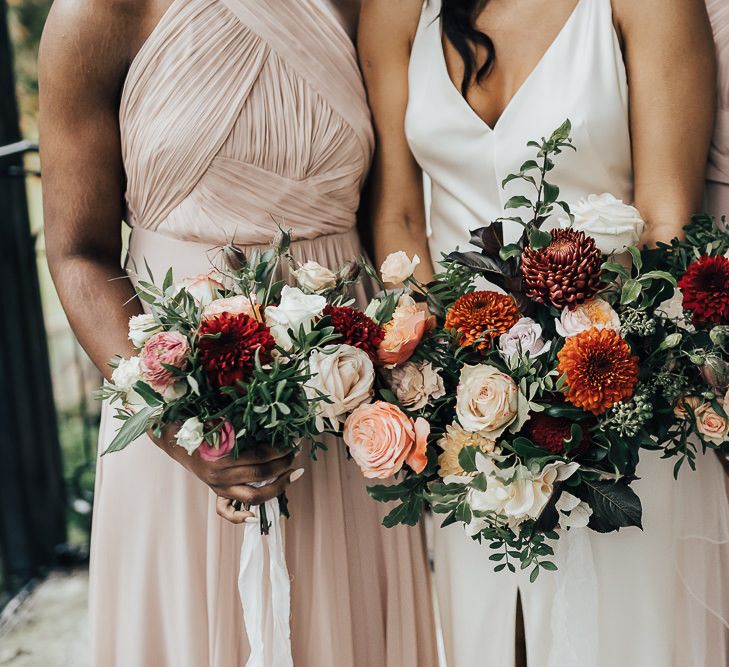 Autumn wedding bouquets with dahlias, roses and foliage