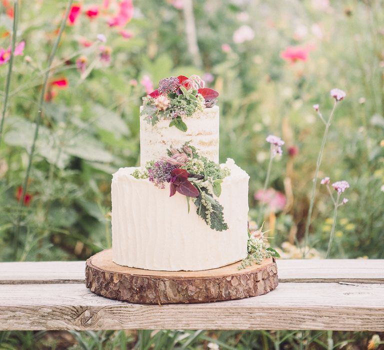 Two Tier Ice Wedding Cake with Flower Decor on a Tree Slice by Clare Makes Cakes | Whimsical De Winton Paper Co. Wedding Stationery Suite | Pastel Peter Rabbit Spring Inspiration at River Cottage | Beatrix Potter | Mr McGreagor's Garden | Succulent Vegetables &amp; Flowers | Jennifer Jane Photography