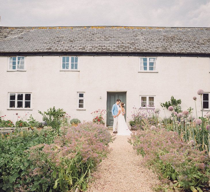 Bride in Lace Wedding Dress with Back Detail | Groom in Pale Blue Jacket &amp; Chino's | Pastel Peter Rabbit Spring Inspiration at River Cottage | Beatrix Potter | Mr McGregor's Garden | Jennifer Jane Photography