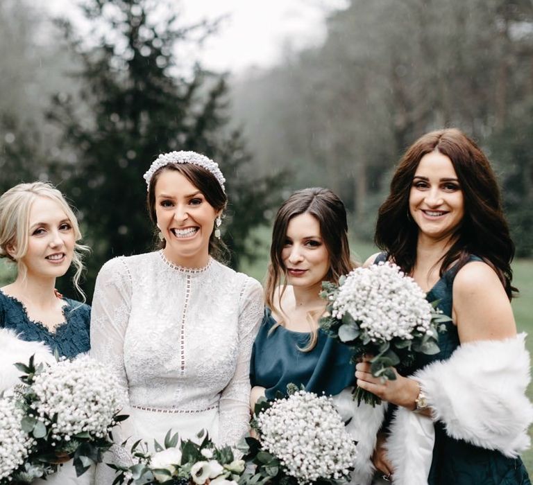 Bride wearing embellished headband and her bridesmaids in green dresses with gypsophila bouquets