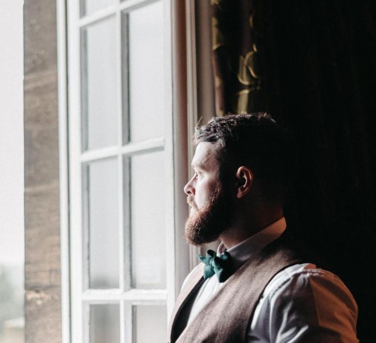 Groom wearing tweed wedding suit at Christmas wedding