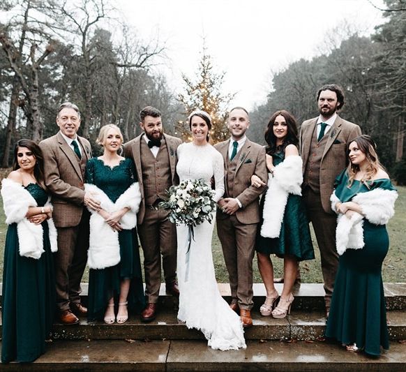 Bride and groom and their party with Christmas styling and tweed wedding suit