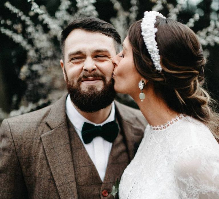 Bride and groom tie the knot at winter celebration with tweed wedding suit