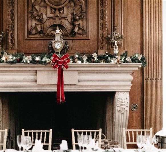 Winter foliage and red bow decor above the top table