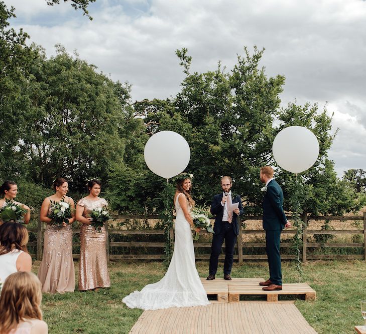 Wedding Ceremony | Giant Balloon Decor | Bride in La Sposa Gown from Mirror Mirror Bridal | Groom in Paul Smith Suit | Outdoor Wedding Ceremony &amp; Tipi Reception Planned by Benessamy Events | Red on Blonde Photography