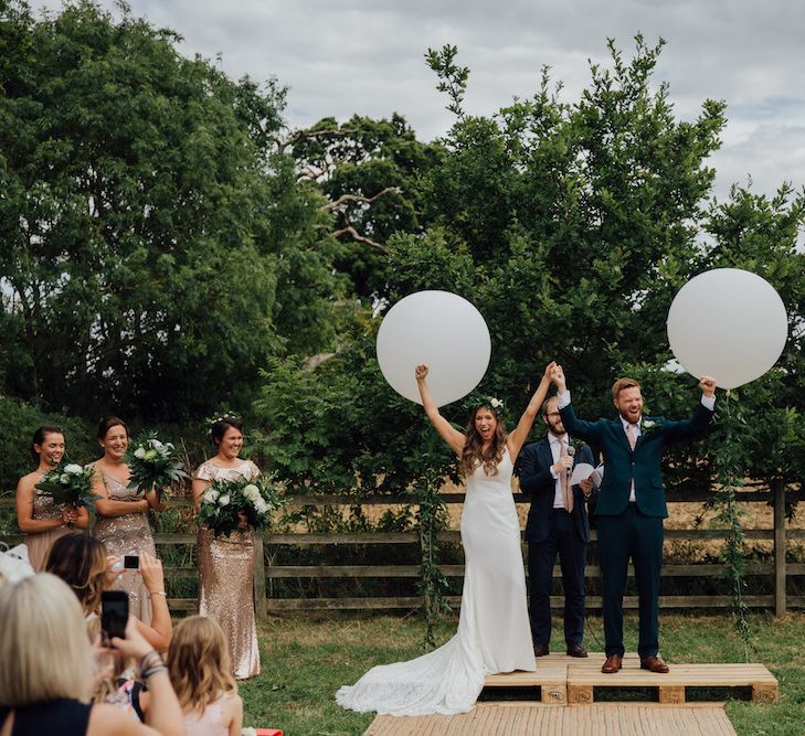 Wedding Ceremony | Giant Balloon Decor | Bride in La Sposa Gown from Mirror Mirror Bridal | Groom in Paul Smith Suit | Outdoor Wedding Ceremony &amp; Tipi Reception Planned by Benessamy Events | Red on Blonde Photography