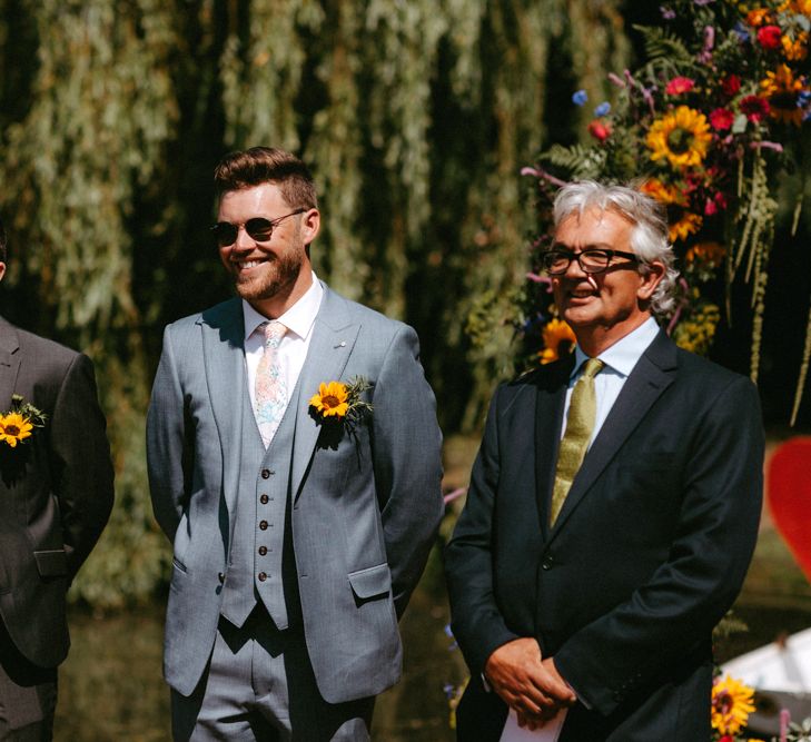 Groomsmen in Ted Baker Suits and sunflower Buttonhole Standing at the Altar