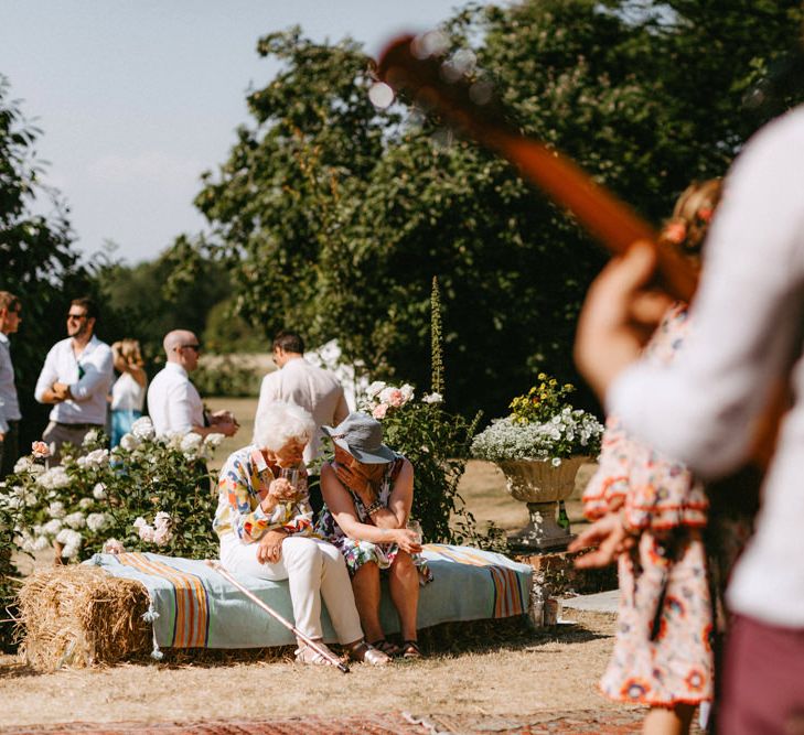 Wedding Guests Sitting on Hay Bales