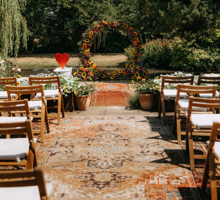 Outdoor Wedding with Persian Rugs and Sunflower Moongate