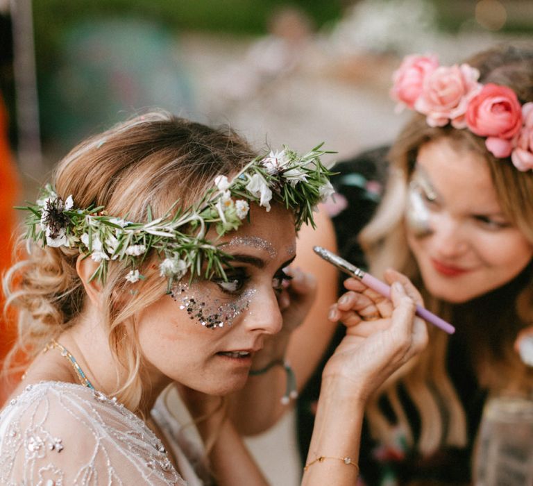 Bride in Jenny Packham Portia Wedding Dress and Flower Crown putting on Face Glitter