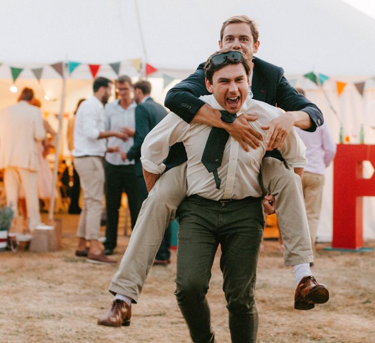 Wedding Guests Enjoying a Piggy Back Ride