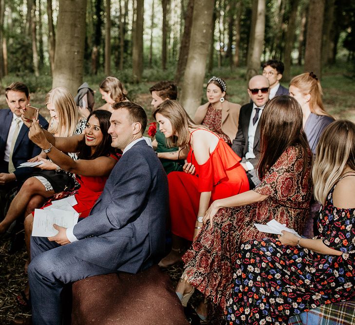 Wedding guests taking selfies at outdoor Evenley Wood Garden wedding