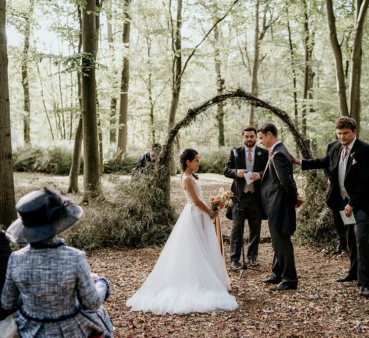 Wedding ceremony at Evenley Wood Garden with moon gate altar