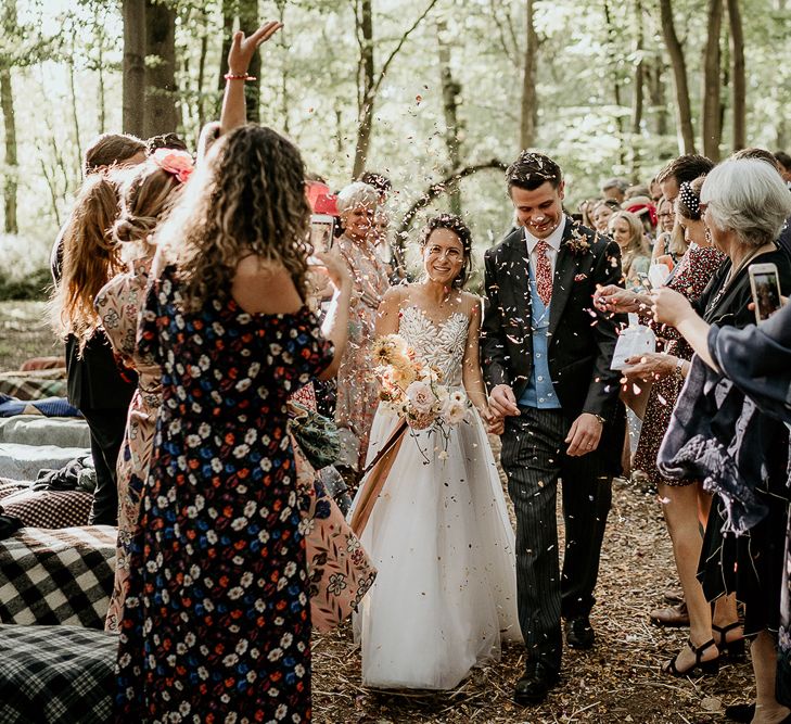 Confetti exit at Evenley Wood Garden woodland wedding ceremony