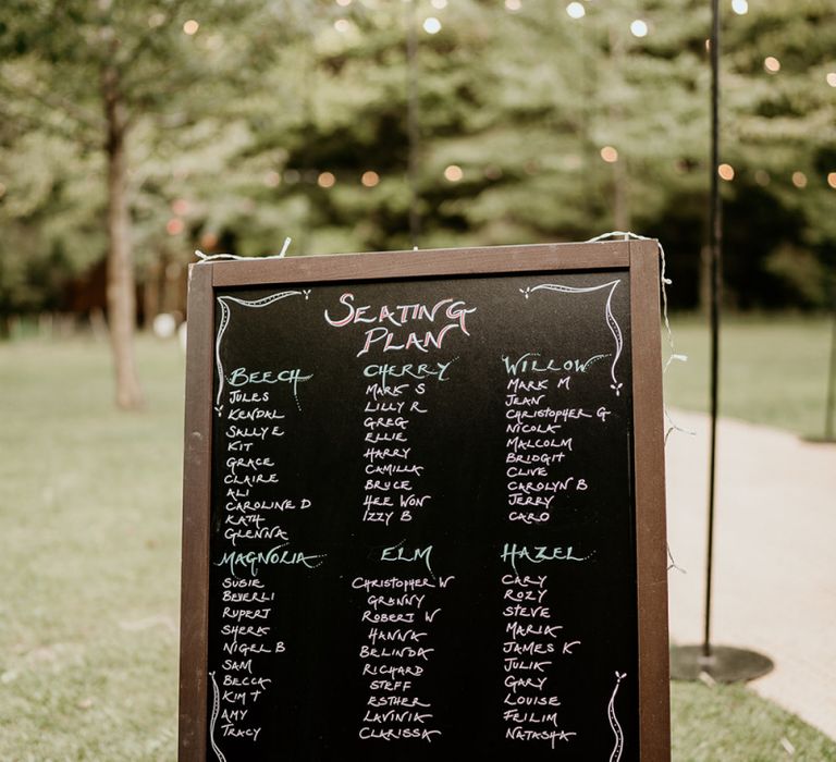 Chalkboard seating chart at Evenley Wood Garden wedding reception