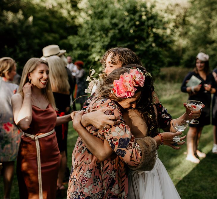 Bride embracing wedding guests