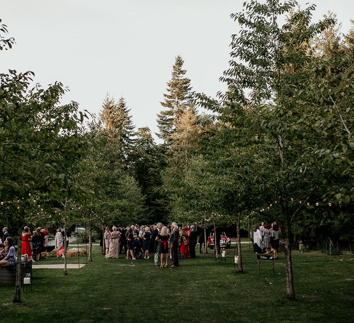 Outdoor wedding reception at Evenley Wood Garden with festoon lights