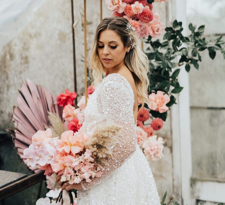 Bride in sparkling bridal gown at for wedding with pink colour scheme