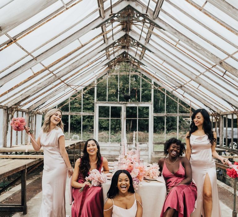 Bridal party portraits with bridesmaids in different shades of pink satin dresses