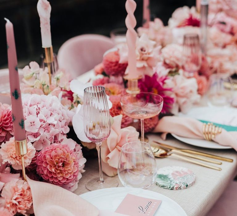 Taper candles and coloured glassware for intimate wedding with pink colour scheme