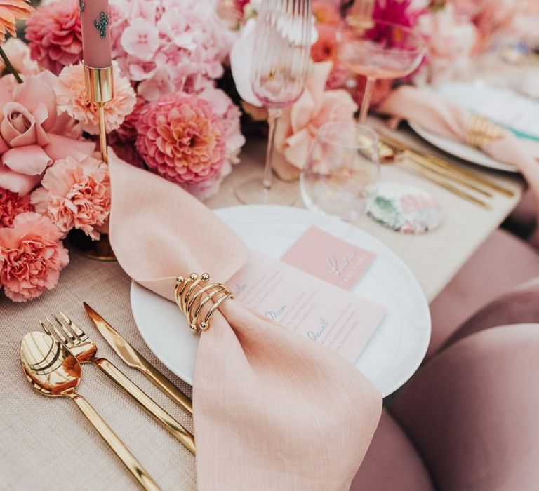 pink colour scheme place setting with blush flowers and gold cutlery