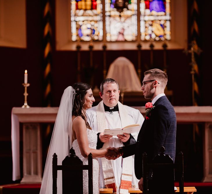 Bride and Groom Exchange Vows At Church Ceremony