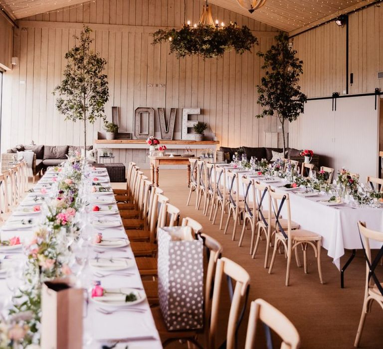 Wedding Table Decor With Foliage Chandelier And Wedding Lights