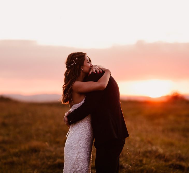 Couple Embrace In Front Of Sunset At Primrose Hill Farm Wedding Venue