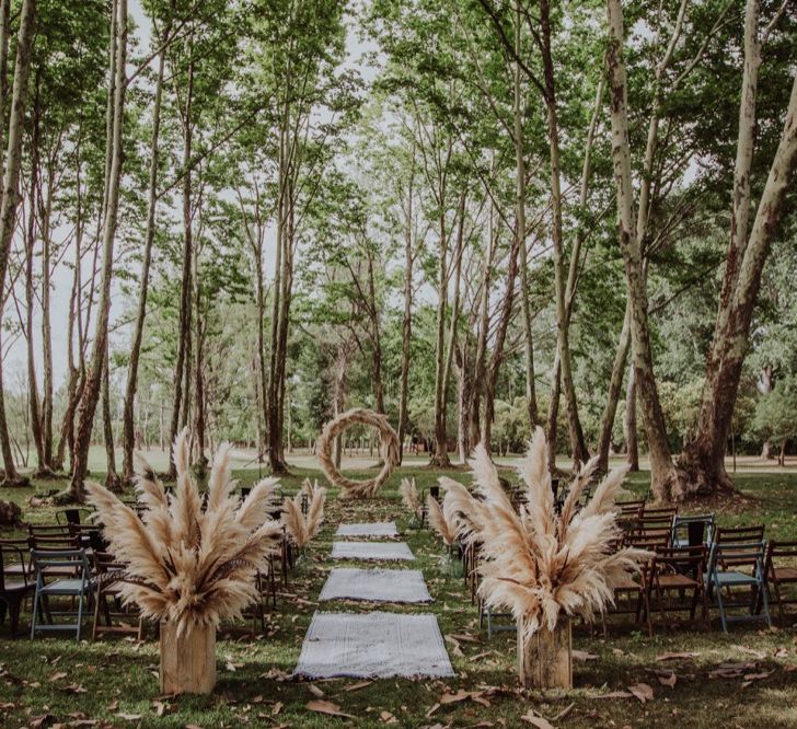 Pampas Grass Moongate &amp; Aisle Floral Arrangements | Outdoor Woodland Wedding at Sa Farinera de Sant LLuis Wedding Venue, Catalan Empordà, Spain | Planned &amp; Styled by Mille Papillons | HUMà06 Photography | HUMà06 Photography