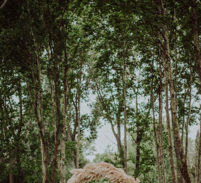 Pampas Grass Moongate &amp; Aisle Floral Arrangements | Outdoor Woodland Wedding at Sa Farinera de Sant LLuis Wedding Venue, Catalan Empordà, Spain | Planned &amp; Styled by Mille Papillons | HUMà06 Photography | HUMà06 Photography