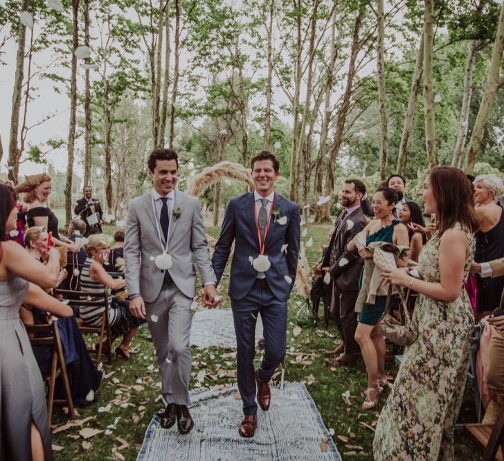 Outdoor Wedding Ceremony | Two Grooms in Grey Suits | Pampas Grass Moon Gate | Woodland Wedding at Sa Farinera de Sant LLuis Wedding Venue, Catalan Empordà, Spain | Planned &amp; Styled by Mille Papillons | HUMà06 Photography | HUMà06 Photography