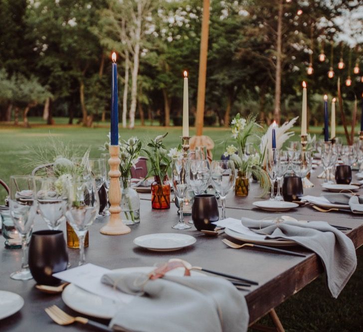 Tapper Candles, Grey Napkins, Black Glasses Table Decor | Outdoor Woodland Wedding at Sa Farinera de Sant LLuis Wedding Venue, Catalan Empordà, Spain | Planned &amp; Styled by Mille Papillons | HUMà06 Photography | HUMà06 Photography