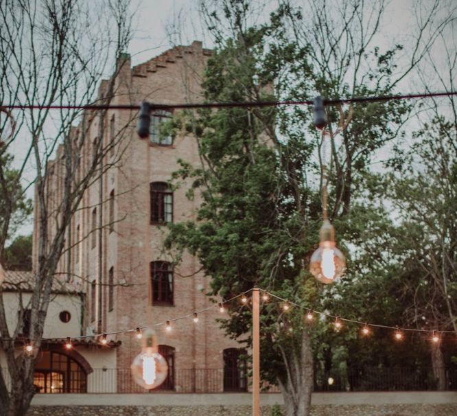 Outdoor Wedding Reception Speeches with Festoon Lights | Woodland Wedding Ceremony at Sa Farinera de Sant LLuis Wedding Venue, Catalan Empordà, Spain | Planned &amp; Styled by Mille Papillons | HUMà06 Photography | HUMà06 Photography