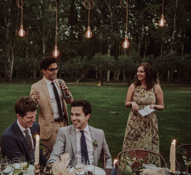 Outdoor Wedding Reception Speeches with Festoon Lights | Woodland Wedding Ceremony at Sa Farinera de Sant LLuis Wedding Venue, Catalan Empordà, Spain | Planned &amp; Styled by Mille Papillons | HUMà06 Photography | HUMà06 Photography