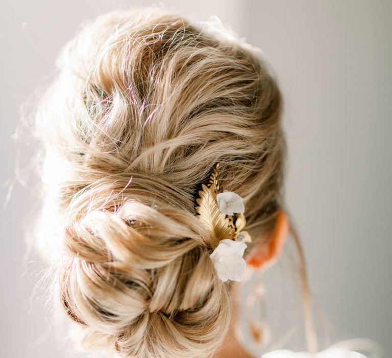 Pinned bun bridal up do with gold hair ccessory